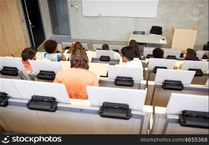 education, high school, university, learning and people concept - group of international students in lecture hall