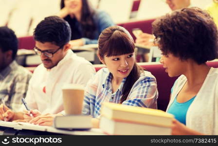 education, high school, university, learning and people concept - group of international students talking on lecture. group of international students talking on lecture