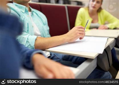 education, high school, university, learning and people concept - group of students with notebooks at lecture hall