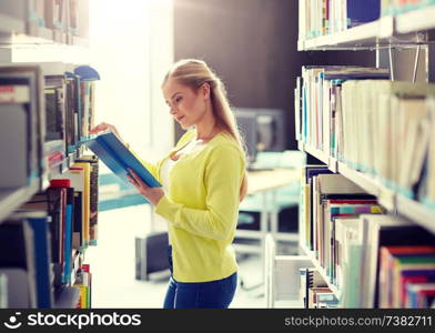 education, high school, university, learning and people concept - smiling student girl reading book at library. high school student girl reading book at library