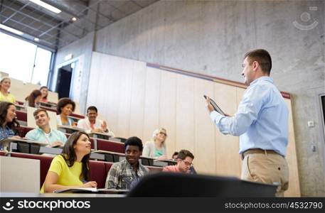 education, high school, university, teaching and people concept - group of international students and teacher with tablet pc computer standing at white board at lecture