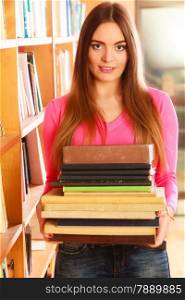 Education highschool concept. Lovely female student fashion long hair girl in college library with stack books.