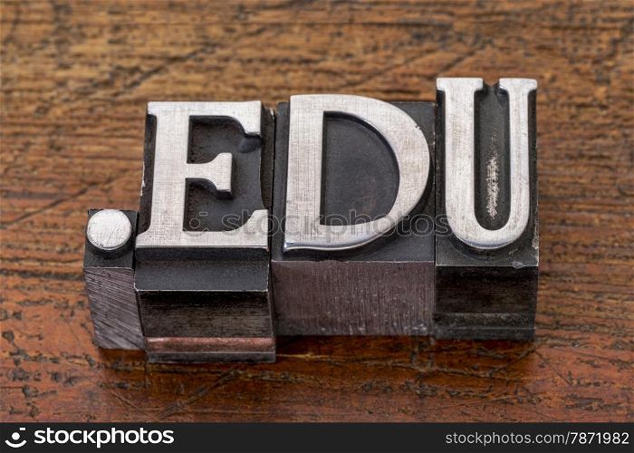 education internet domain - dot edu in mixed vintage metal type printing blocks over grunge wood