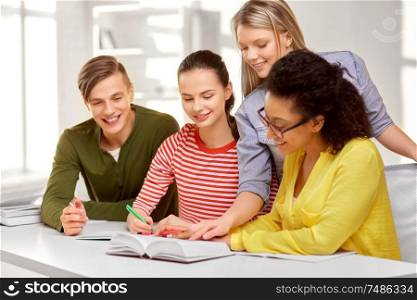 education, learning and people concept - happy high school students or classmates with books and notebooks. high school students with books and notebooks