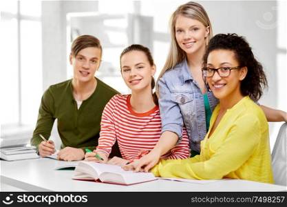 education, learning and people concept - happy high school students or classmates with books and notebooks. high school students with books and notebooks