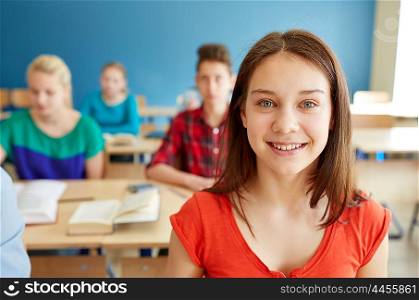 education, learning and people concept - happy student girl at school lesson