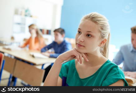 education, learning and people concept - happy student girl at school lesson