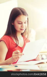 education, learning and people concept - happy student girl with test paper at school. happy student girl with test paper at school