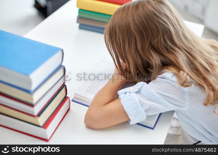 education, learning, children and people concept - close up of student girl with many books at school desk