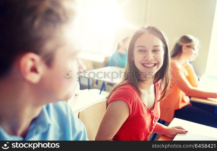 education, learning, communication and people concept - group of happy students talking at school break. group of happy students talking at school break