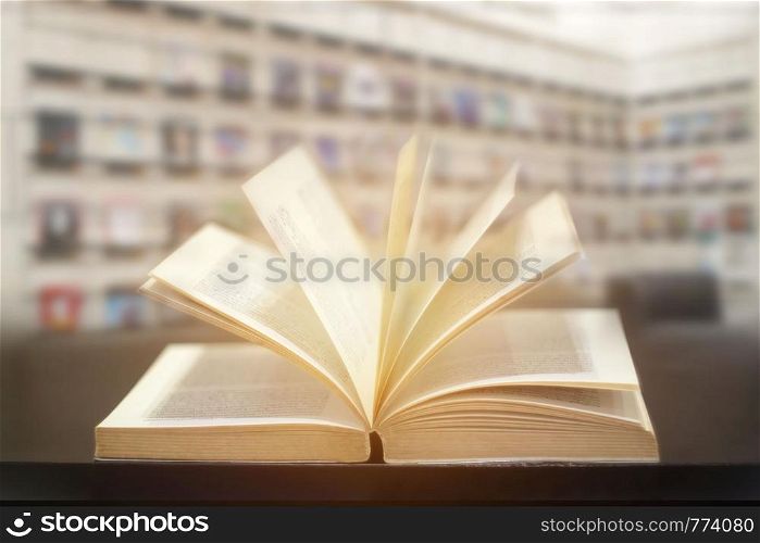 Education learning concept with opening book or textbook in modern library background.