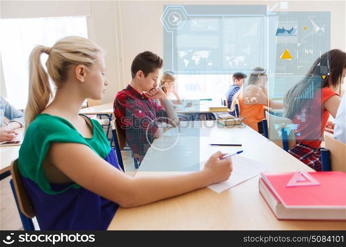 education, learning, statistics and people concept - group of students writing school test over virtual screens with charts. group of students writing school test. group of students writing school test