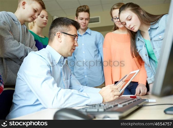 education, learning, teaching, technology and people concept - group of students and teacher with tablet pc computer at school