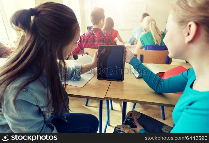 education, learning, technology, friendship and people concept - happy student girls with tablet pc at high school. happy student girls with tablet pc at high school