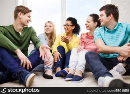 education, leisure and happiness concept - five smiling teenagers having fun at home