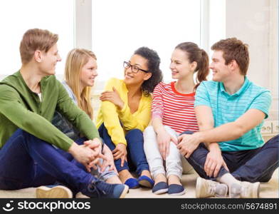 education, leisure and happiness concept - five smiling teenagers having fun at home