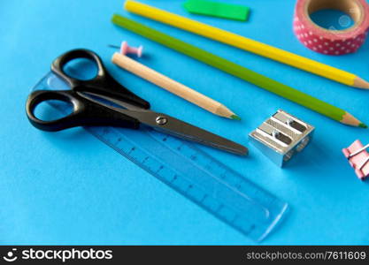 education, office and object concept - close up of stationery or school supplies on blue background. stationery or school supplies on blue background