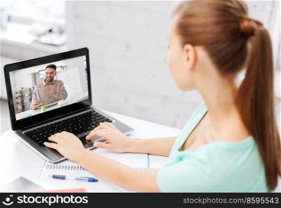 education, online school and distance learning concept - student woman with teacher showing wind turbine model on laptop computer screen having video call at home. student woman with laptop learning online at home