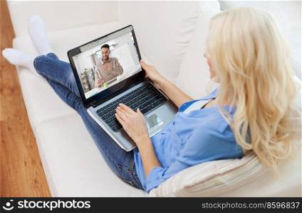 education, online school and distance learning concept - woman with laptop watching tutorial video at home. woman with laptop watching tutorial video at home