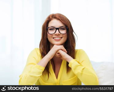 education, people and happiness concept - smiling teenage girl in eyeglasses at home