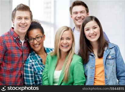 education, people, friendship and learning concept - group of happy international high school students or classmates