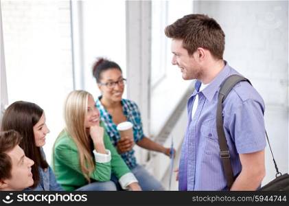 education, people, friendship, communication and learning concept - group of happy international high school students or classmates with folders