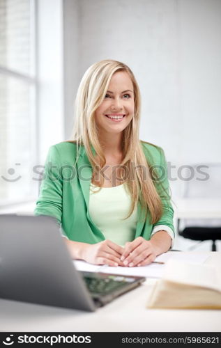 education, people, technology and learning concept - happy student girl with laptop at school