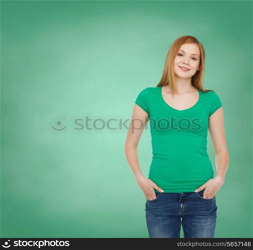 education, school, advertisement and people concept - smiling teenage girl in casual clothes over green board background