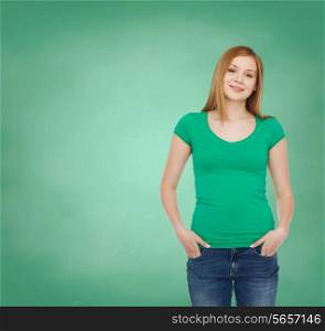 education, school, advertisement and people concept - smiling teenage girl in casual clothes over green board background