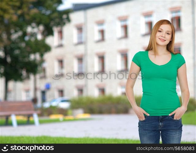 education, school, advertisement and people concept - smiling teenage girl in casual clothes over campus background