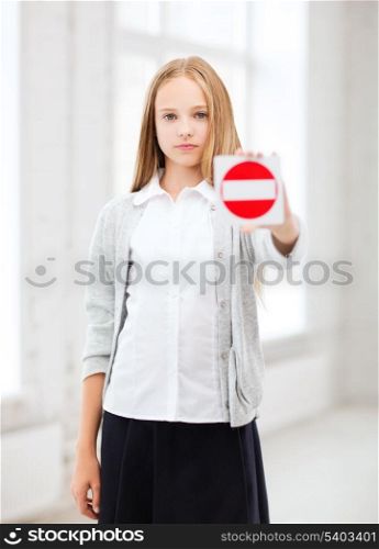 education, school and anti-bullying concept - student girl showing stop sign