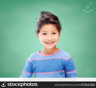 education, school and children concept - little student girl over green chalk board background