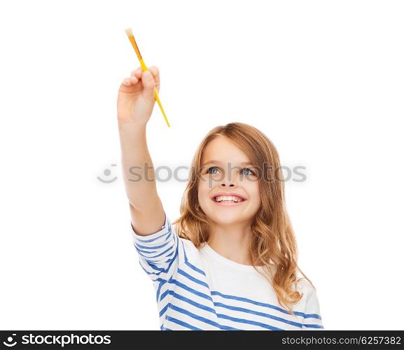 education, school and imaginary screen concept - cute little girl drawing with brush in the air or imaginary screen