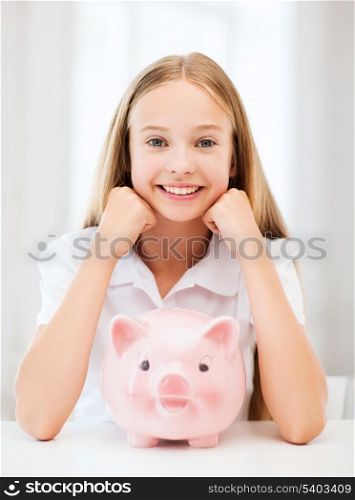 education, school and money saving concept - child with piggy bank