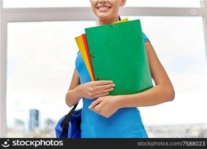 education, school and people concept - close up of smiling student woman with bag and folders. close up of student woman with bag and folders