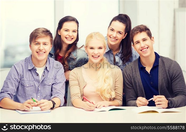 education, school and people concept - group of smiling students having fun at school