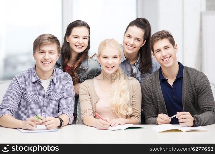 education, school and people concept - group of smiling students having fun at school