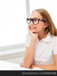 education, school and people concept - happy smiling student girl in black eyeglasses with book. happy student girl in glasses with book at school