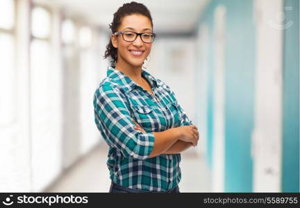 education, school and people concept - smiling young woman in eyeglasses at school