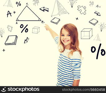 education, school and technology concept - cute little girl pointing to triangle on virtual screen