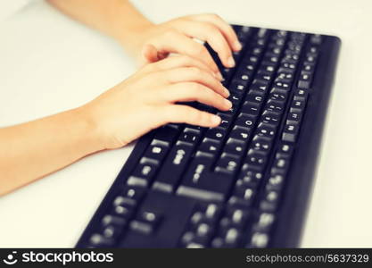 education, school and technology concept - little student girls hands typing on keyboard