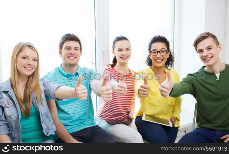 education, school and technology concept - smiling students with tablet pc computers at school