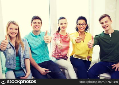 education, school and technology concept - smiling students with tablet pc computers at school