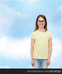 education, school and vision concept - smiling cute little girl in black eyeglasses