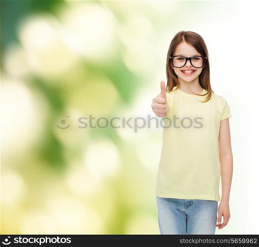 education, school and vision concept - smiling cute little girl in black eyeglasses showing thumbs up