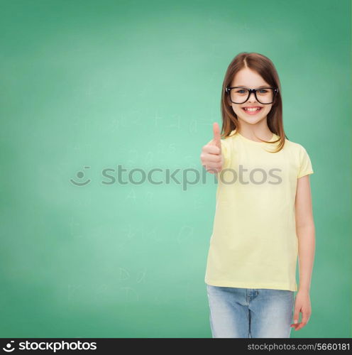 education, school and vision concept - smiling cute little girl in black eyeglasses showing thumbs up