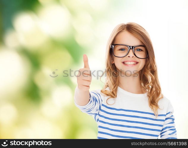 education, school and vision concept - smiling cute little girl with black eyeglasses showing thumbs up gesture