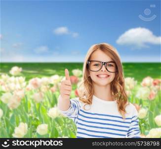 education, school and vision concept - smiling cute little girl with black eyeglasses showing thumbs up gesture