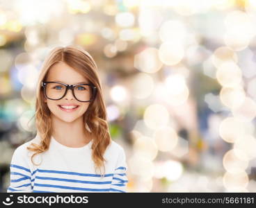 education, school and vision concept - smiling cute little girl with black eyeglasses