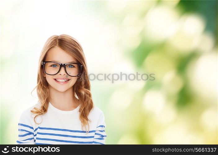 education, school and vision concept - smiling cute little girl with black eyeglasses